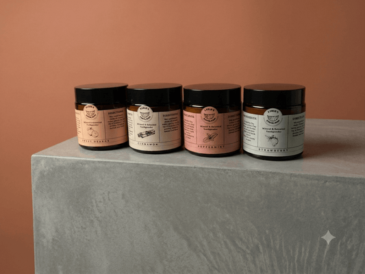 Herbal mineral tooth powder for kids displayed in jars on a grey surface, showcasing natural oral care options.